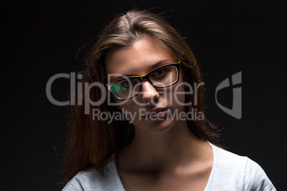 Portrait of serious teenager girl in shadow