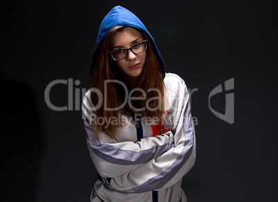 Serious teenager girl in shadow with arms crossed