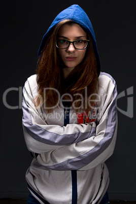 Teenager girl in shadow with arms crossed