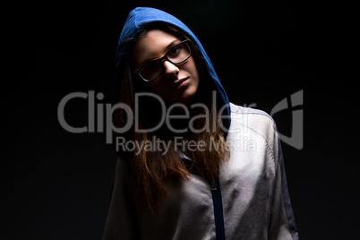 Teenager girl in shadow with hood