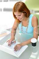 Student girl sitting behind modern desk laptop