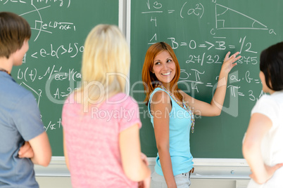 Students standing front of green chalkboard math