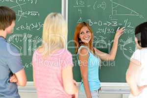 Students standing front of green chalkboard math