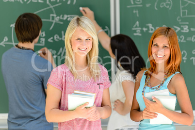 Two smiling student girls in math class