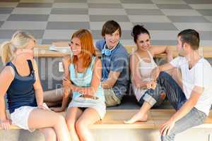 Students talking sitting on school bench