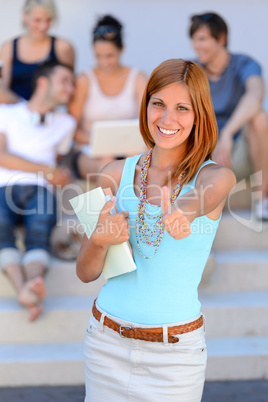 Smiling student girl thumb-up friends background