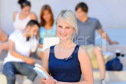 Teenage student girl smiling friends in background