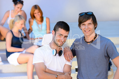 Two student boys standing outside college summer