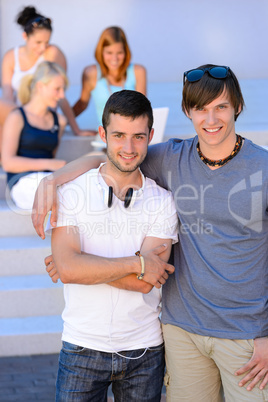 Two student boys standing outside college summer