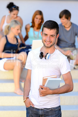 Smiling student boy friends sitting college steps