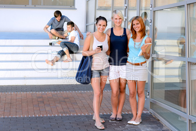 Student girl friends smiling front of college
