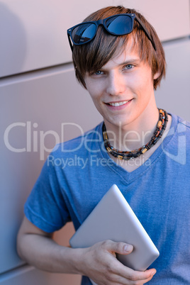 Student boy with tablet looking at camera