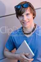 Student boy with tablet looking at camera