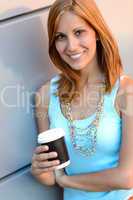 Smiling student girl with coffee cup summer
