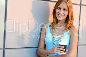 Smiling student girl holding coffee cup summer