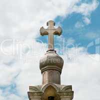 stone cross on the sky background