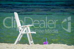 Bucket and deckchair of a wonderful beach. Relaxation abstract
