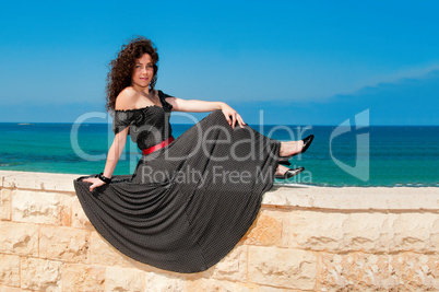 Girl in a beautiful dress against the sea