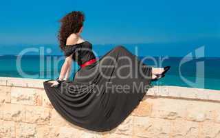 Girl in a beautiful long dress against the sea