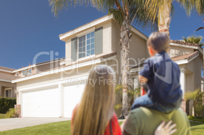 Mixed Race Young Family Looking At Beautiful Home