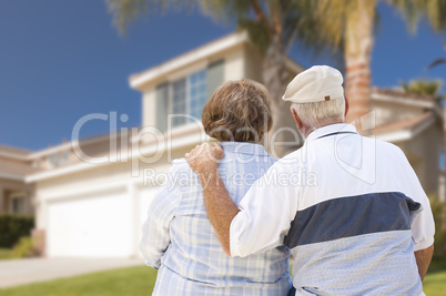 Happy Senior Couple Looking at Front of House