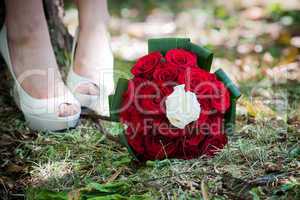 Bride shoes with wedding bouquet