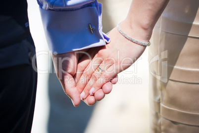 Young married couple holding hands