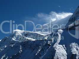 Strong wind blowing snow over a ridge