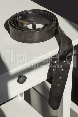 Mens belt on a bedstand