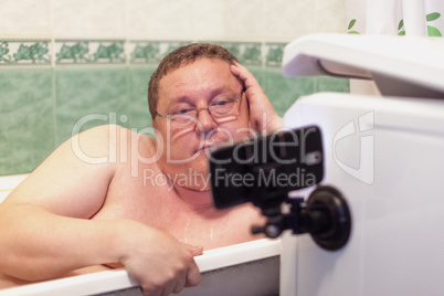 Man relaxing in a  bathtub