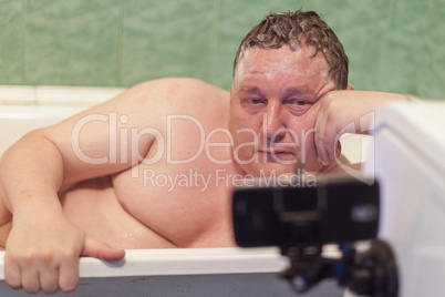 Man relaxing in a  bathtub