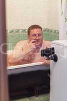 Man relaxing in a  bathtub