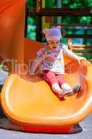 Small girl having fun on a slide