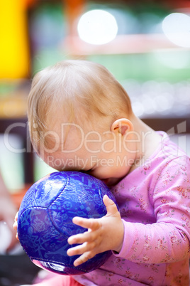 Cute little baby playing with a ball