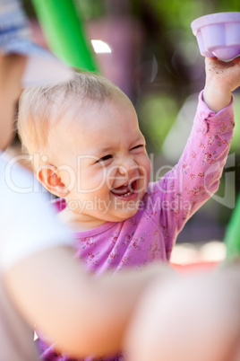 Laughing little baby playing with a toy