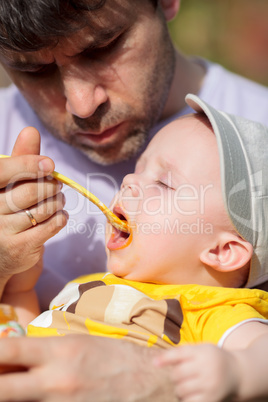 Daddy feeding toddler