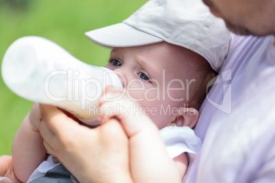 Man bottle feeding baby