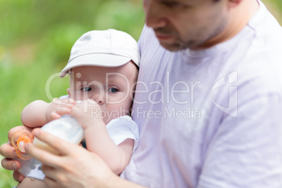 Father feeding his baby from the bottle