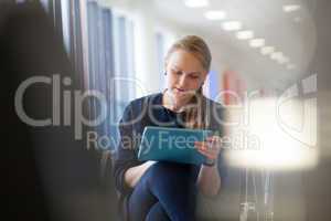 Young woman with pad in the waiting room