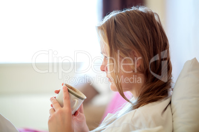 Candid portrait of a woman drinking coffee
