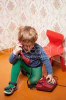 Young boy using red phone