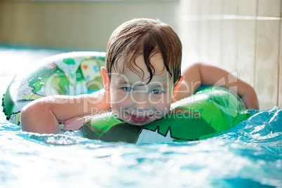 Young boy in inflatable tube swimming