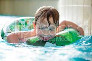 Young boy in inflatable tube swimming