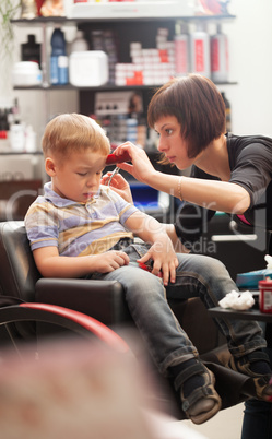 Little boy at the hairdresser