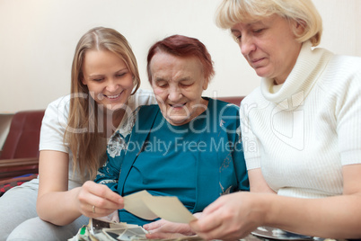 Mother, daughter and grandma looking at photos
