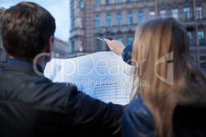 Man and woman holding blueprint