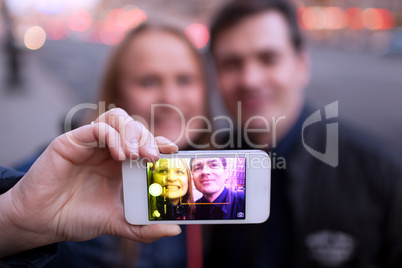 Happy couple taking self portrait