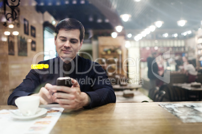 Gentleman sitting at the table using phone