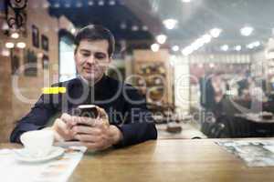 Gentleman sitting at the table using phone