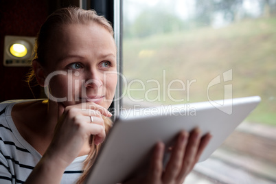 Smiling young woman traveling by train